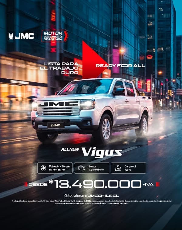Camioneta JMC Vigus en ciudad con luces y reflejos urbanos.