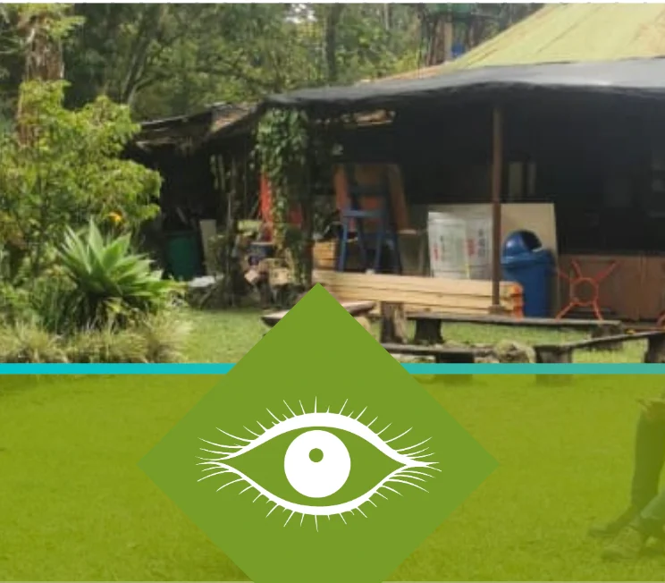 Sustainable ecovillage shelter with greenery and eye logo.
