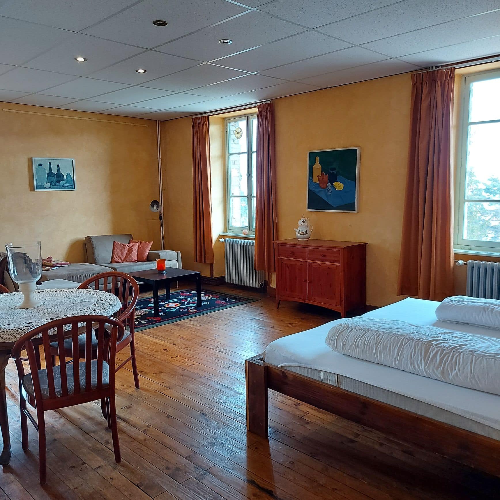 Cozy living room with wooden furniture and warm orange walls.