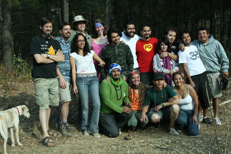 Group of diverse volunteers outdoors in a forest setting for Bosque Village project.