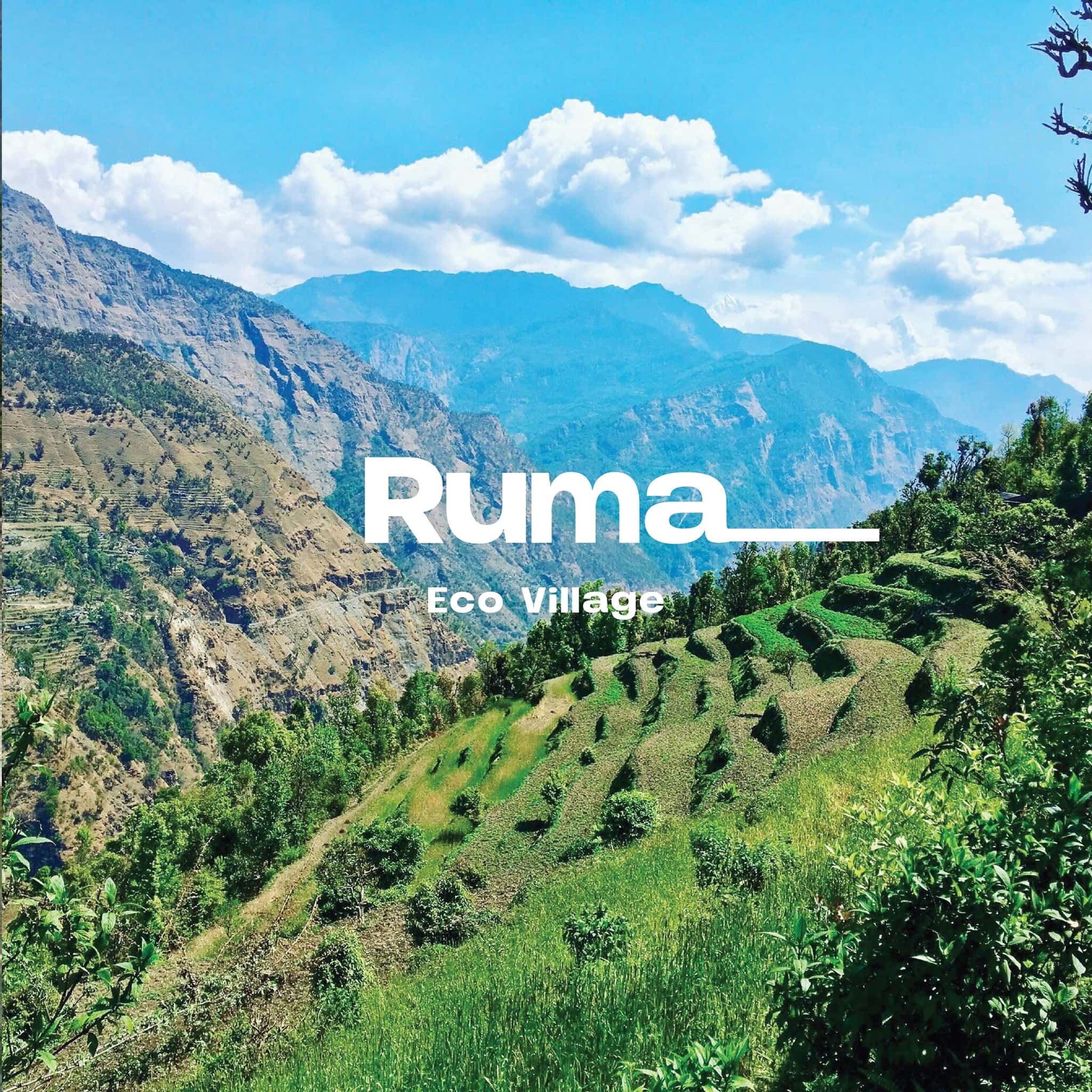 Ruma Eco Village terraced hills with green fields and mountains.