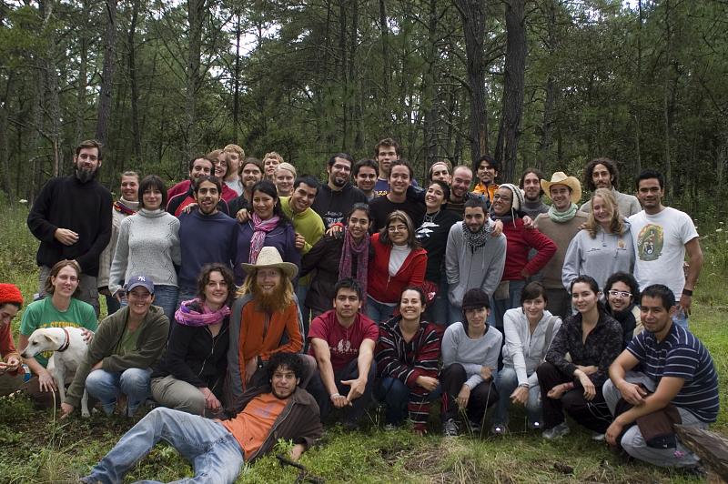 Group photo of diverse participants at a forest ecovillage event in Bosque Village.