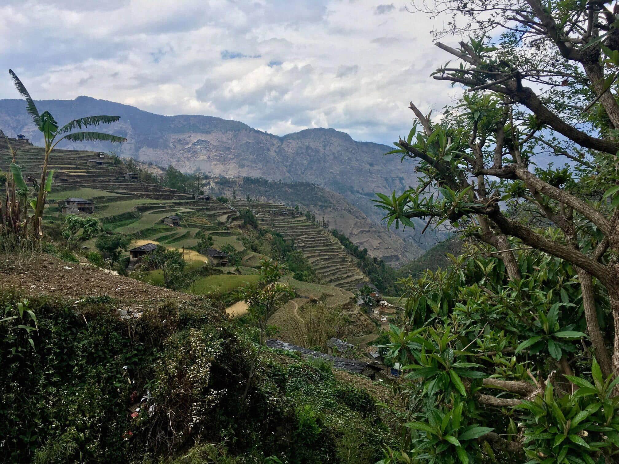 Terraced hillside farms in a mountainous eco village landscape.