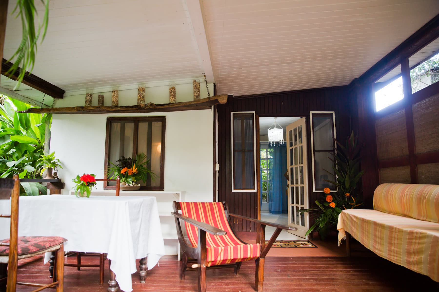 Outdoor veranda at Balenbouche Estate with seating and plants.