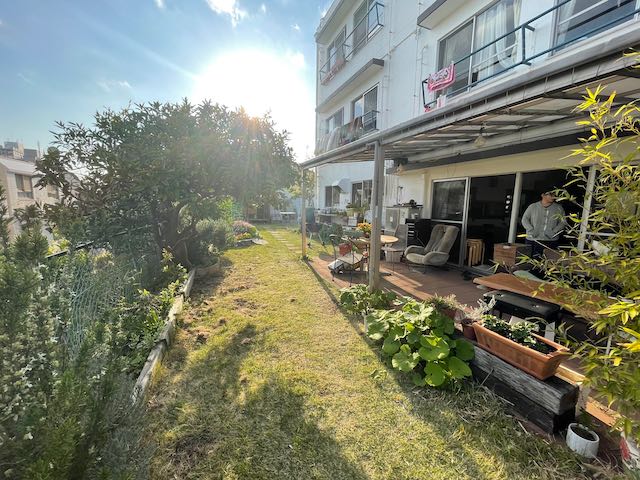 Community garden and patio area beside a residential building.