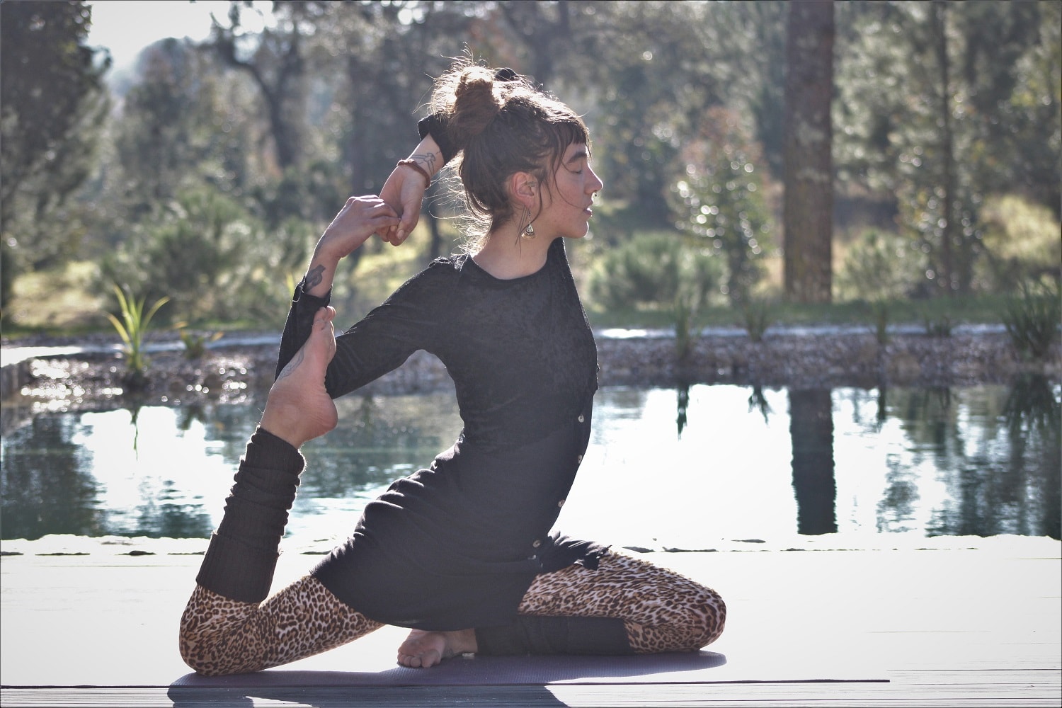Yoga practitioner performing a backbend in leopard print leggings.