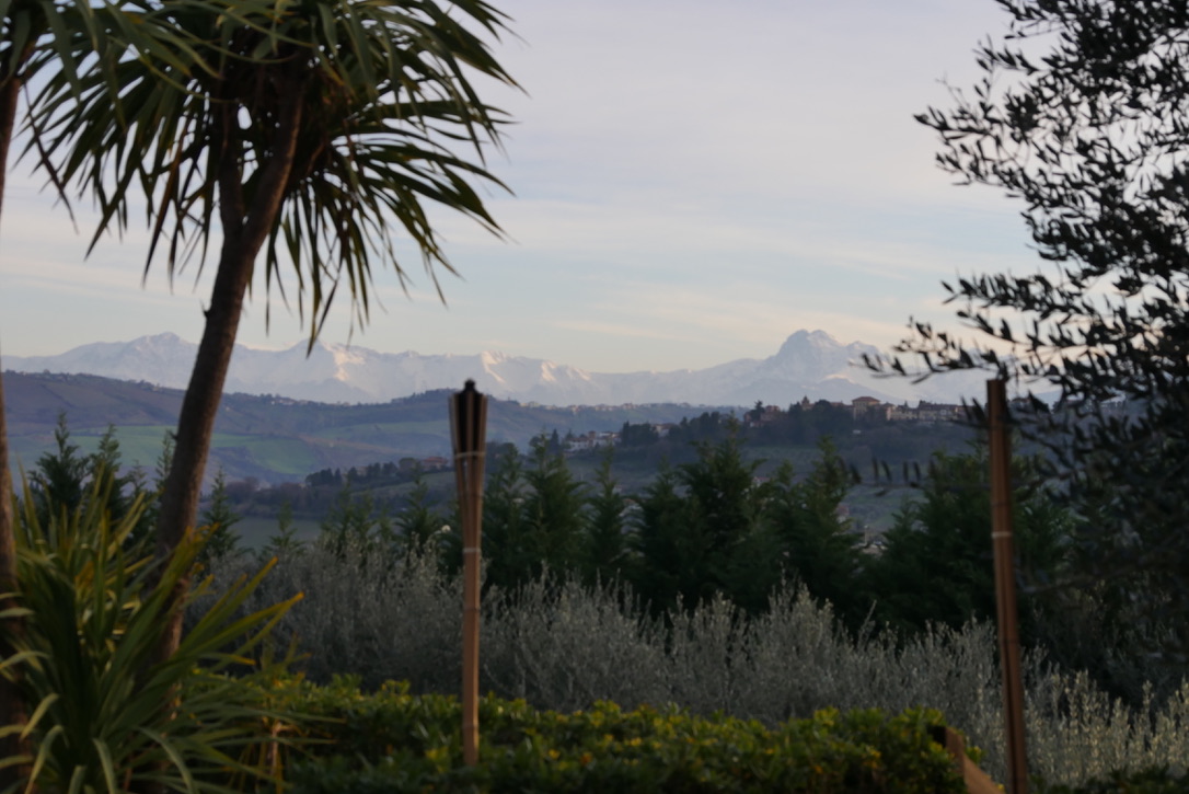 Scenic valley view with distant mountains and garden in foreground.