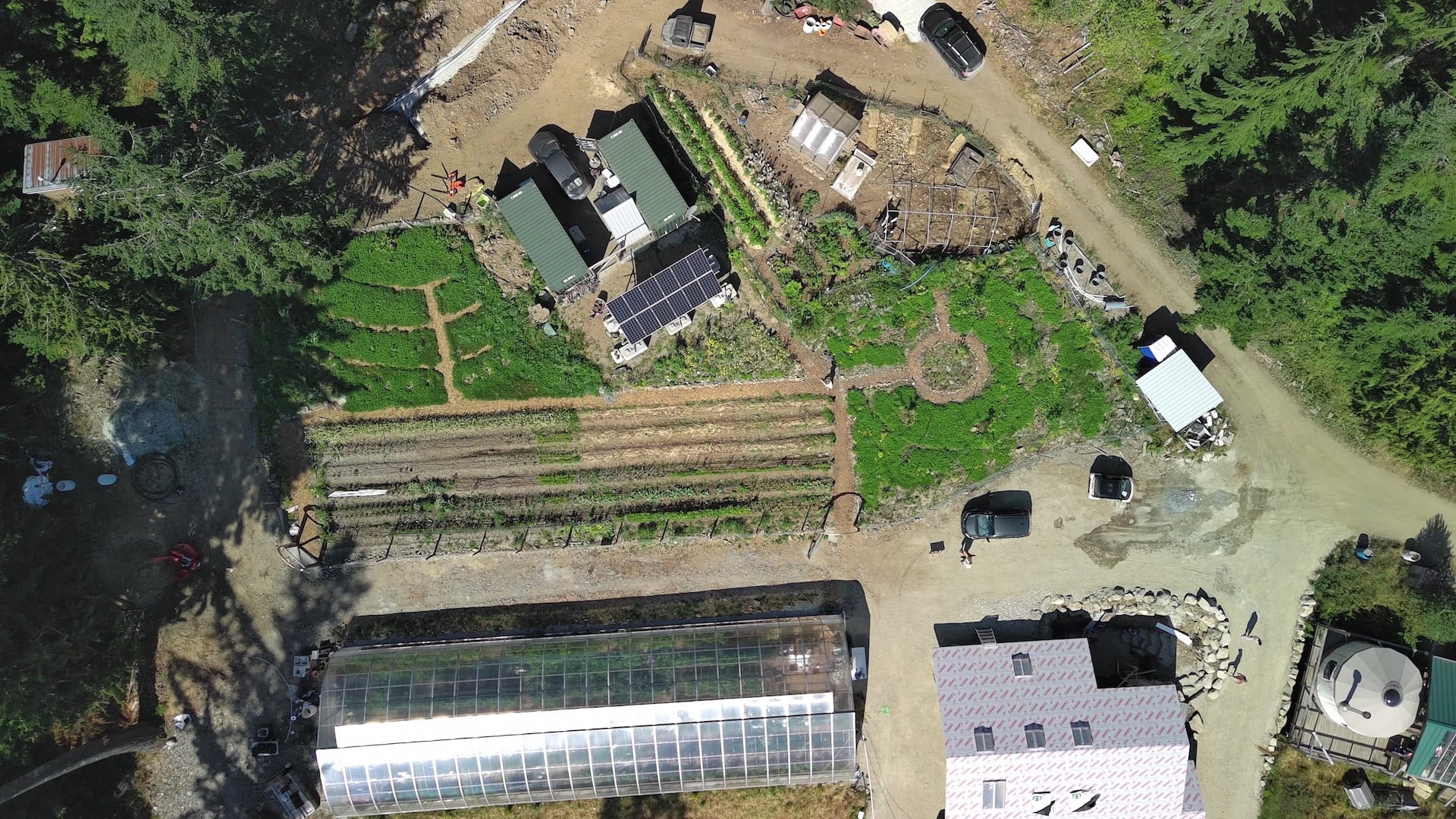Aerial view of forest gardens and solar greenhouse in eco village.