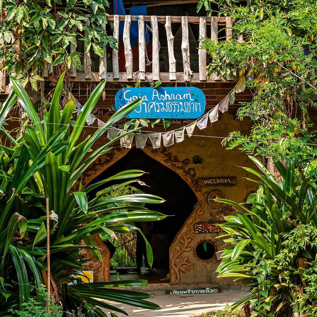 Entrance to Gaia Ashram surrounded by tropical plants and greenery.