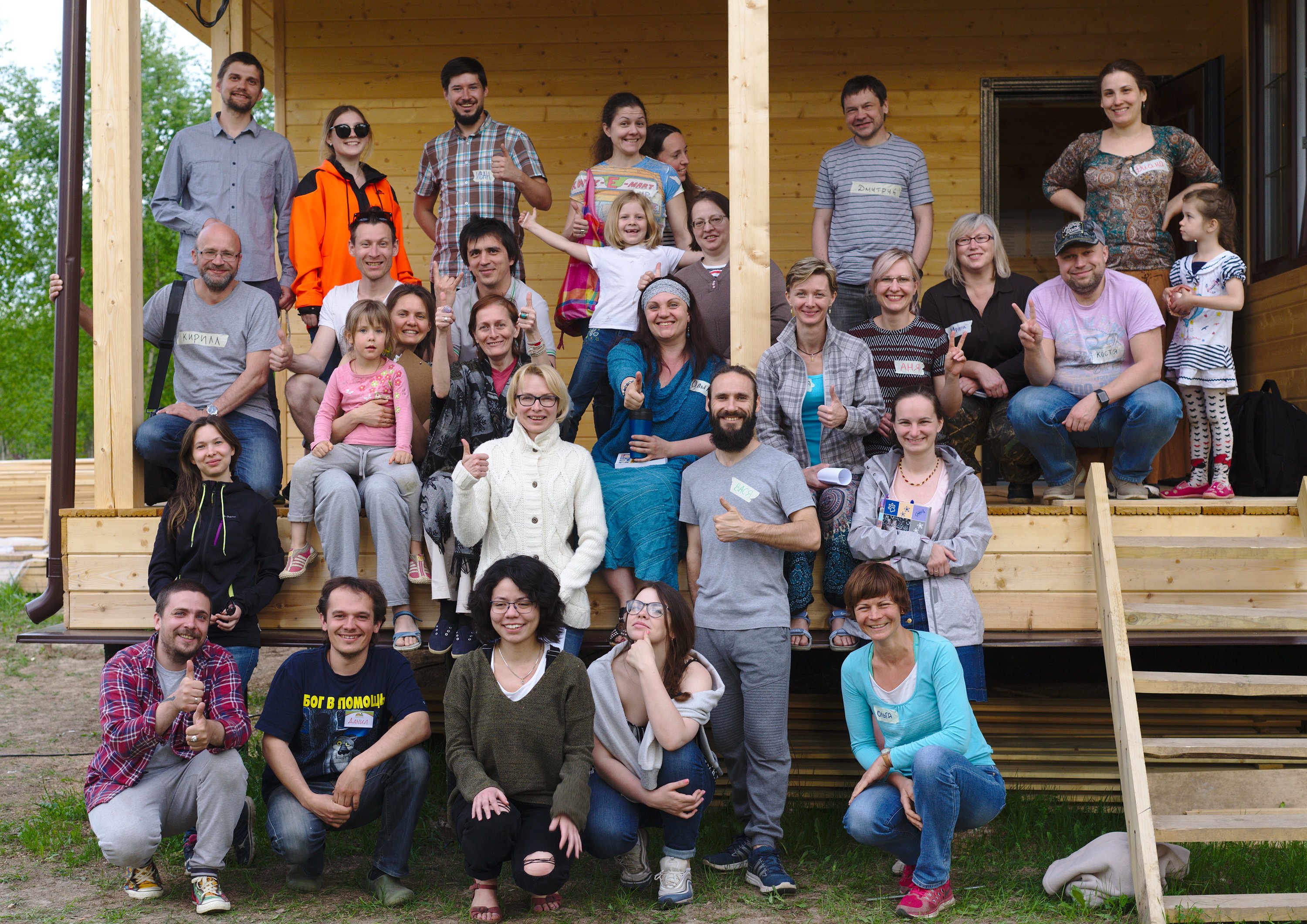Group photo of diverse participants at an ecovillage community event.