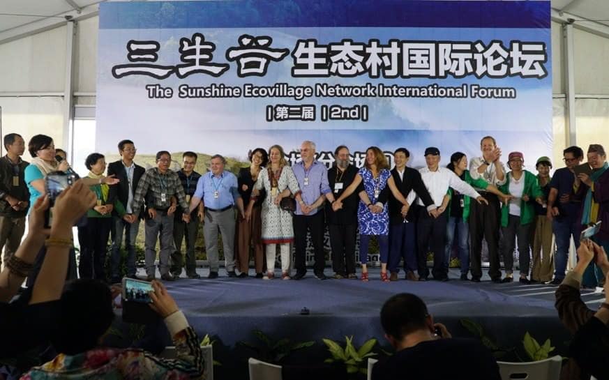People on stage at the Sunshine Ecovillage Network International Forum.