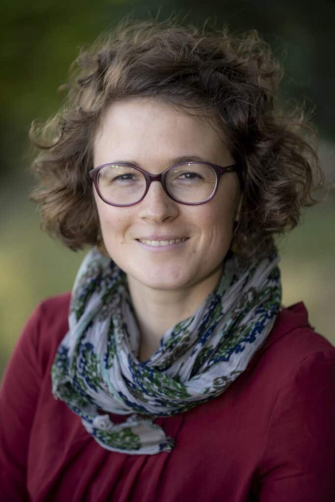 Esther Hirsch portrait with glasses and scarf.