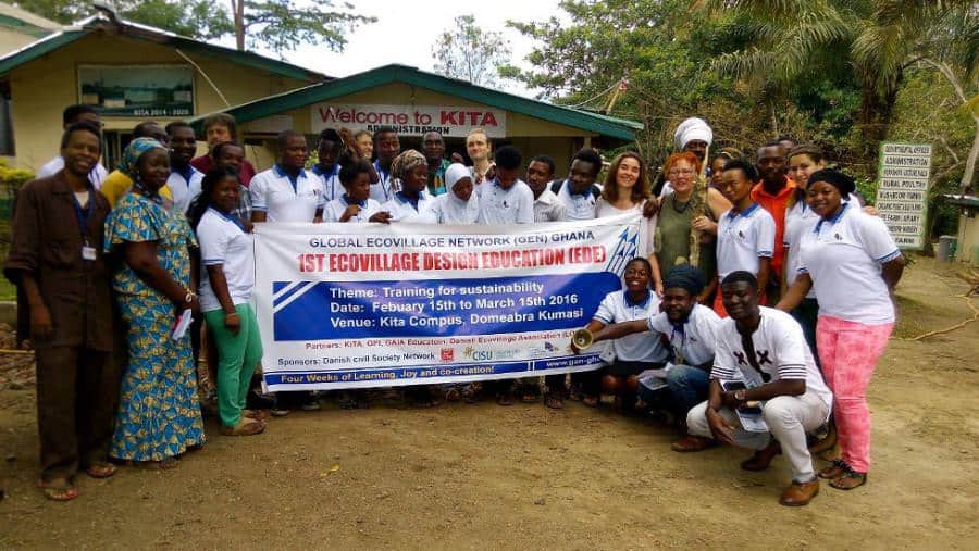 Group photo at KITA with banner for ECOVILLAGE training in Ghana.