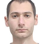 Portrait of a young man with neutral expression.