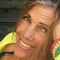 Smiling woman outdoors with colorful wristbands for eco living.