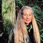 Portrait of Jashana Kiper in a forest setting with long blonde hair.