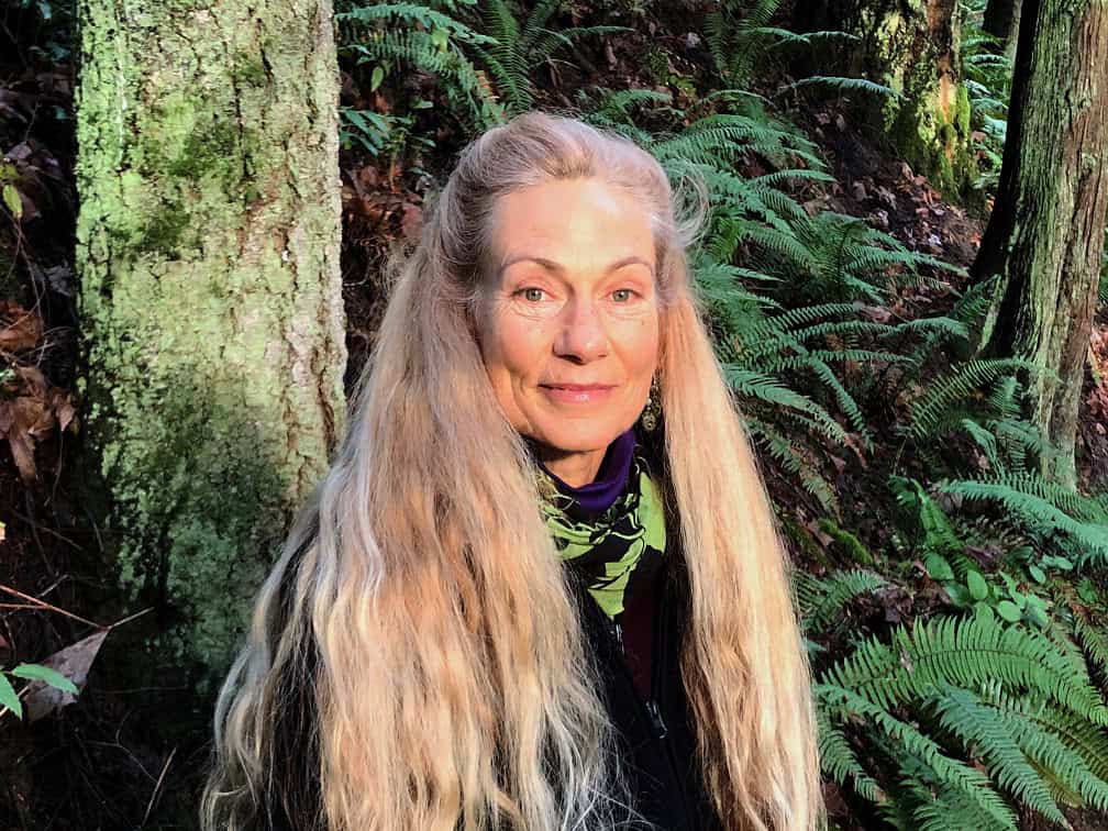 Portrait of Jashana Kiper in a forest setting with long blonde hair.