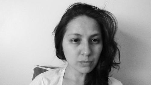 Portrait of a woman, thoughtful expression, black and white photograph.