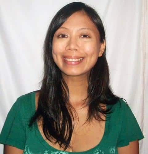 Smiling woman in green top, portrait for Global Ecovillage Network image.