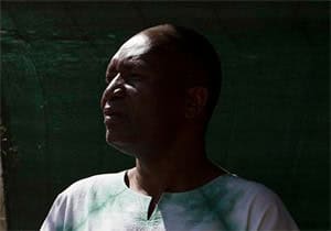 Portrait of a person in soft light, contemplative expression.