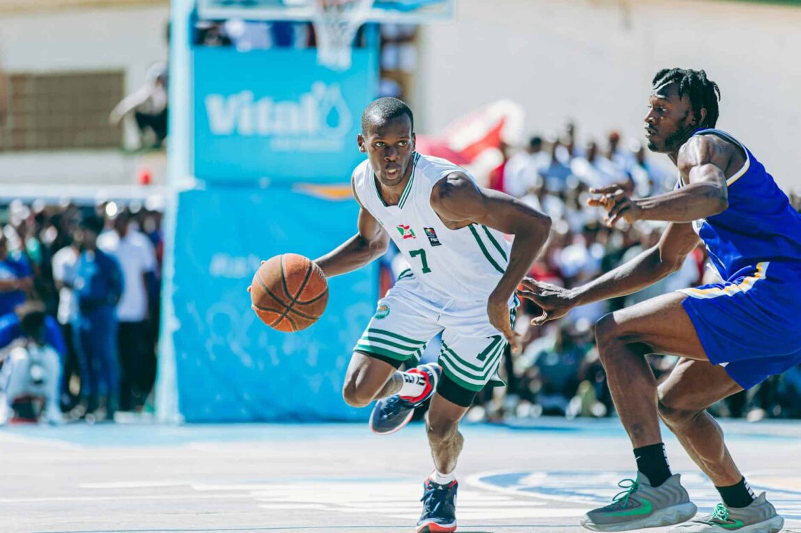 ALT here: Intense basketball game with players in action on the court.