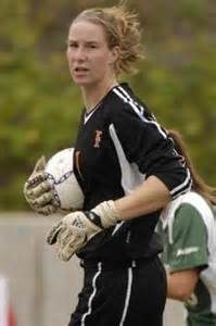 A soccer goalkeeper holds the ball during a game