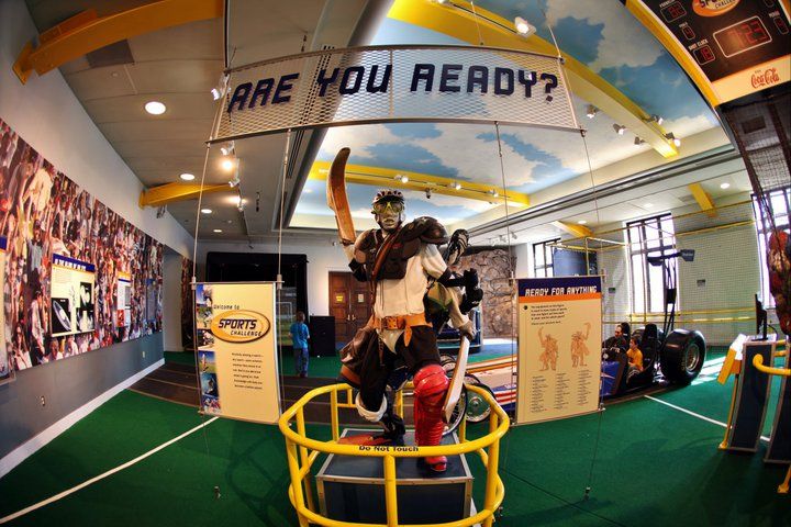Summer Camps: Picture of an athlete with multiple pieces of sports equipment