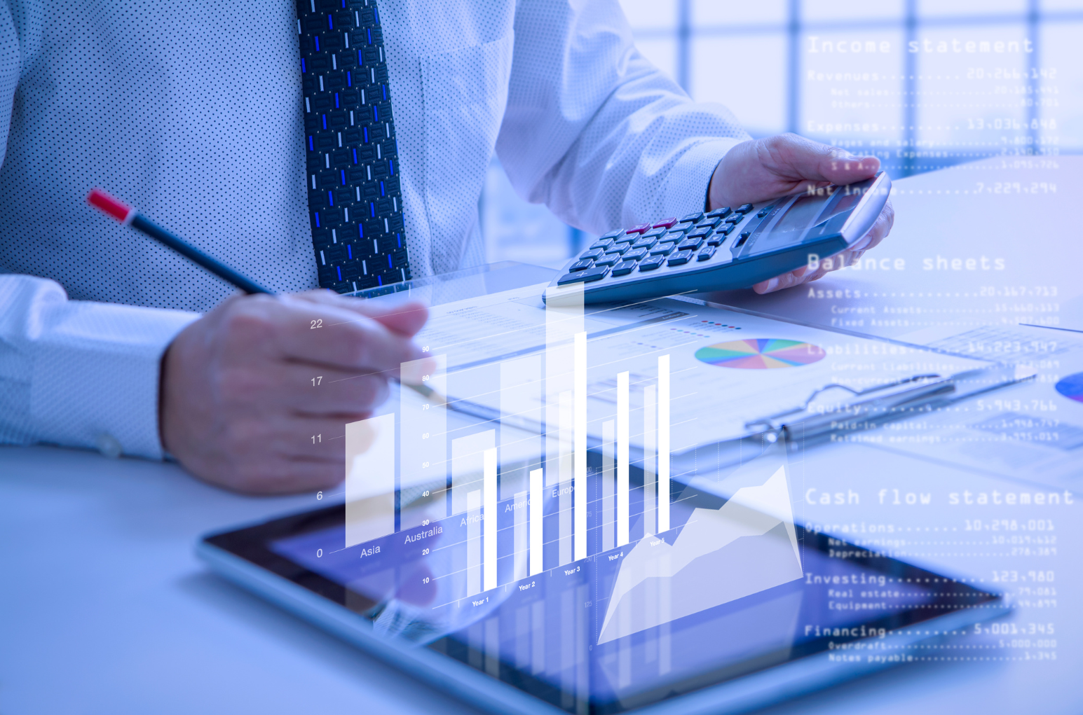 A business professional holding a calculator and a pencil, working with financial charts and data on a tablet, representing financial analysis, strategic financial planning, and outsourced CFO services.