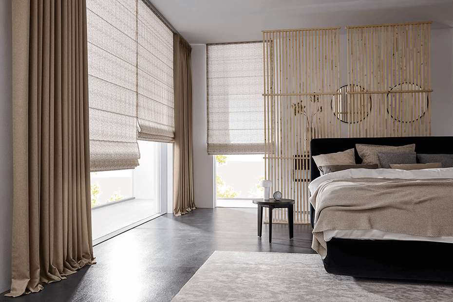 Bedroom with beige Roman shades and matching drapery, creating a cozy and stylish ambiance.
