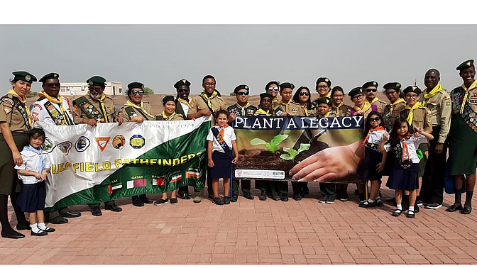 1. Gruppe von Scouts und Kindern bei Umweltaktion mit Bannern "Plant a Legacy" und "Ulfield Pathfinder" in offenem Bereich, engagiert für Umweltschutz und nachhaltige Initiativen.