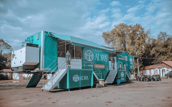 Modulares ADRA Info- und Kommunikationsbus bei einer Veranstaltung in Deutschland, vielseitig einsetzbar für soziale Projekte und Bildungsarbeit. Perfekt für mobile Unterstützung und Informationsvermittlung.