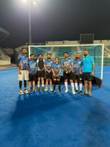 Advocate Sonali Sardana with her hockey team holding the Best Female Player trophy and the overall Bronze medal at the DHCBA tournament.