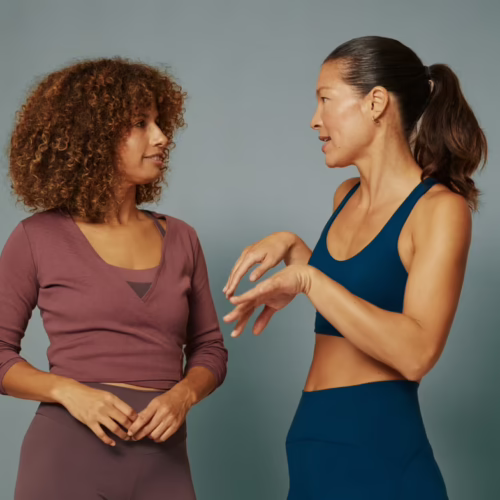 Two women in activewear talking, representing brain fog, cognitive health, and whole-body wellness