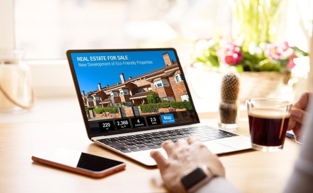 ALT: Real estate for sale listing on laptop screen showcasing eco-friendly properties.