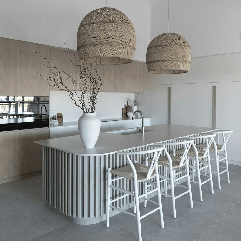 Close-up of a luxurious kitchen island countertop crafted from pristine white quartz, showcasing its smooth, non-porous surface and elegant appearance.