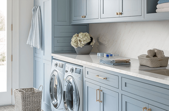 Stylish laundry room featuring durable Calacatta Premata Premium Natural Quartz countertops and backsplash, complementing light blue cabinetry and an integrated utility sink