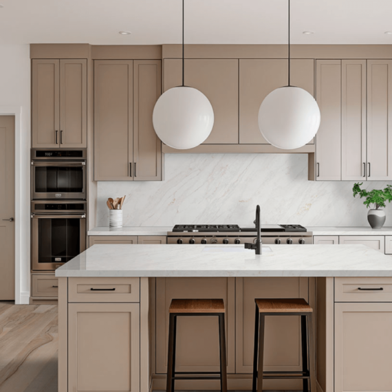 Modern kitchen featuring Calacatta Premata Premium Natural Quartz countertops and backsplash, complementing beige cabinetry and a spacious island with pendant lighting.