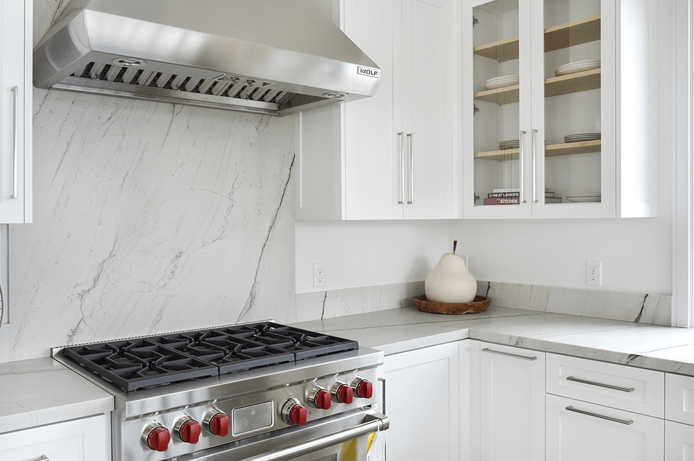 Elegant kitchen with Luce Di Luna quartzite countertops, featuring seamless installation and a beautiful natural stone appearance with subtle veining.