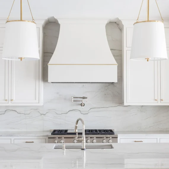 Kitchen design with Luce Di Luna quartzite countertops and a matching full-height backsplash, showcasing natural stone veining and a cohesive look.