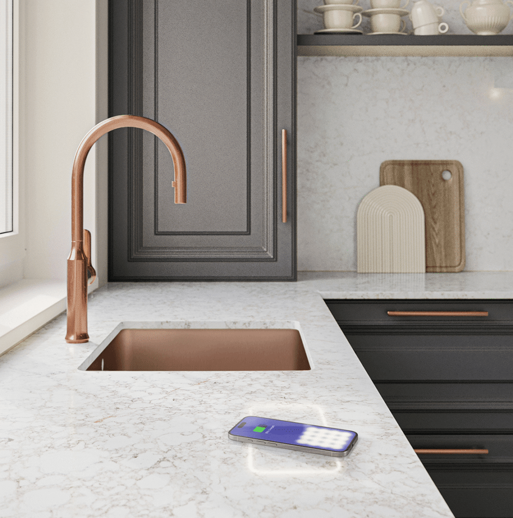 Modern kitchen countertop featuring hidden wireless charging technology seamlessly embedded in stone, installed by Arlington Marble, Fort Worth.