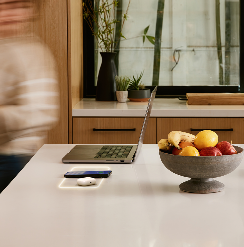 Wireless phone charging integrated inside a stone kitchen countertop, offering a seamless and modern kitchen solution by Arlington Marble, Fort Worth.