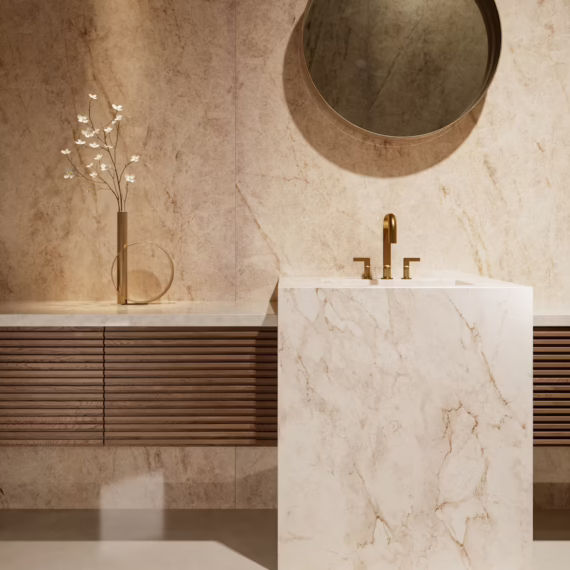 Luxury bathroom remodel with a floor-to-ceiling Tajnar stone accent wall and a Landr stone pedestal vanity by Arlington Marble.