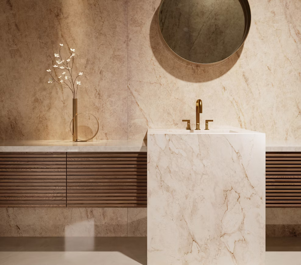 Luxury bathroom remodel with a floor-to-ceiling Tajnar stone accent wall and a Landr stone pedestal vanity by Arlington Marble.