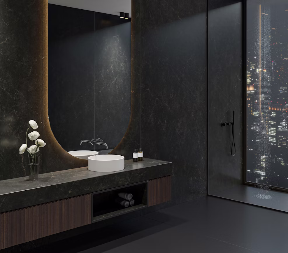 Moody penthouse bathroom remodel with a custom Phantome dark stone floating vanity and full wall cladding by Arlington Marble.