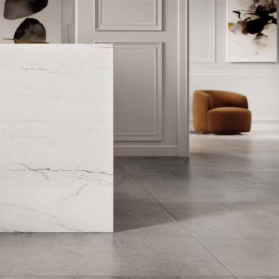 Close-up of bright white luxury mineral surface with subtle gray and gold veining.