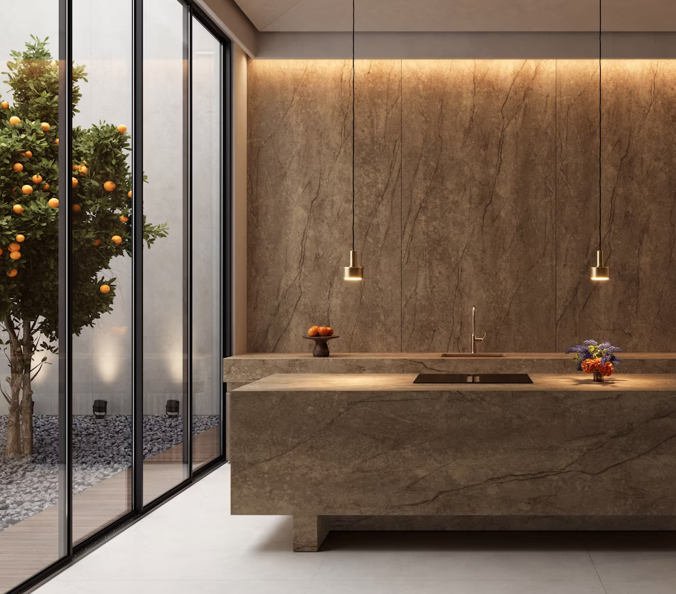 Biophilic luxury kitchen remodel featuring a monolithic stone island and full wall paneling in Cosentino Eclos Legnd by Arlington Marble.