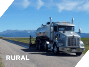 Rural asphalt truck on road for paving and construction work.