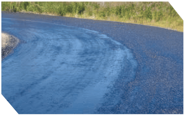 Freshly paved asphalt road with smooth surface and curved layout.