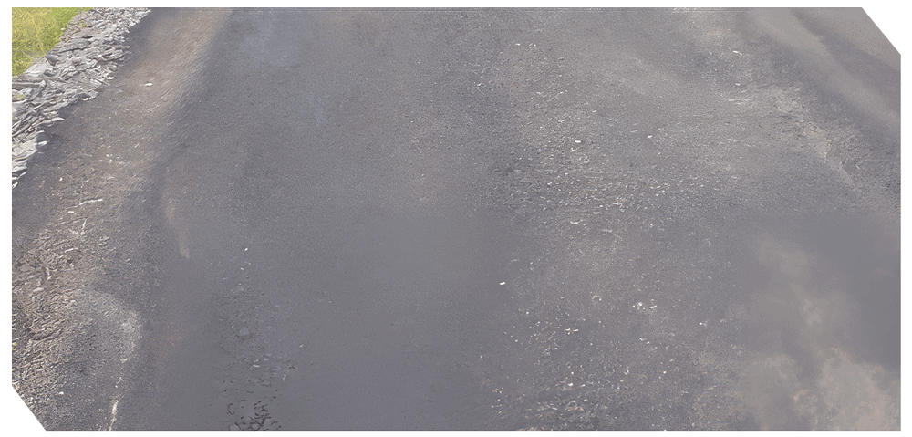 Asphalt repair work on a road surface by Asphalt Systems Inc.