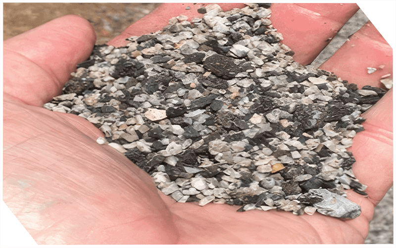 Close-up of asphalt aggregate sample for paving projects.